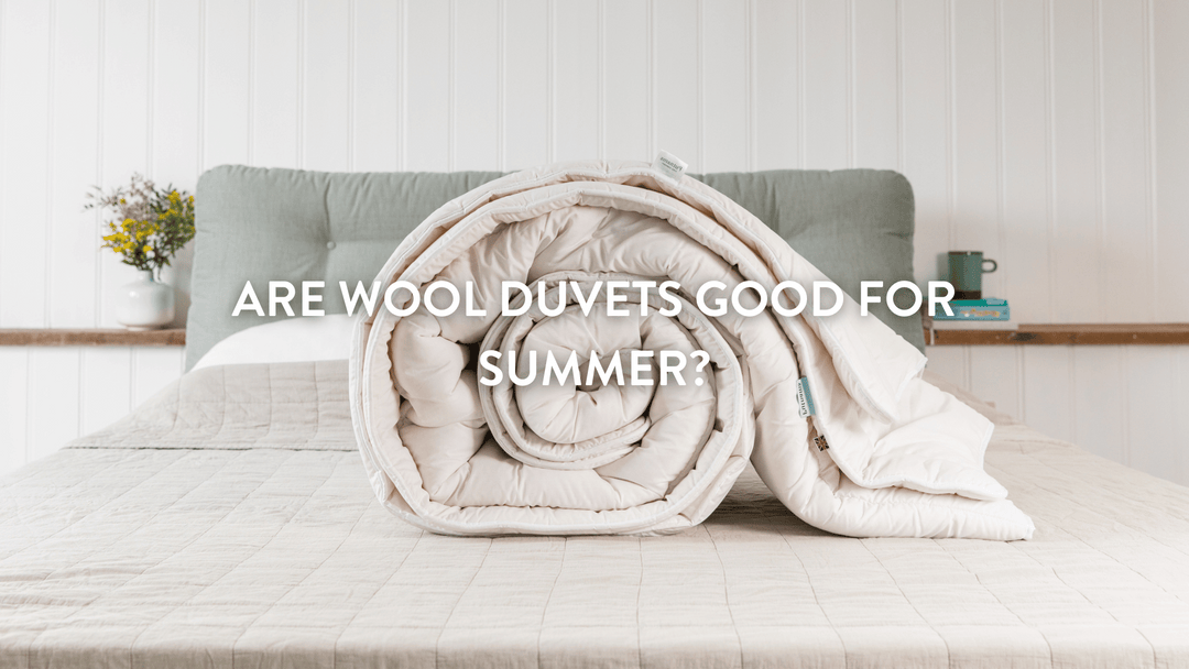 Putnams wool duvet rolled up on bed 