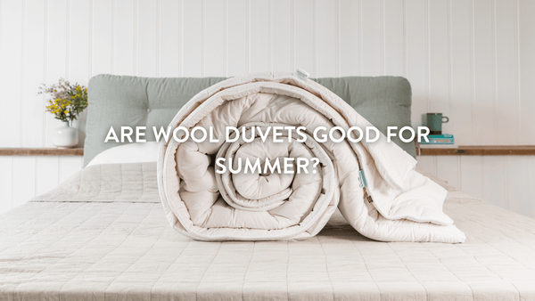 Putnams wool duvet rolled up on bed 